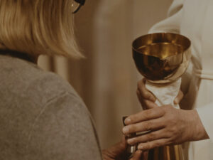 A woman is receiving communion.